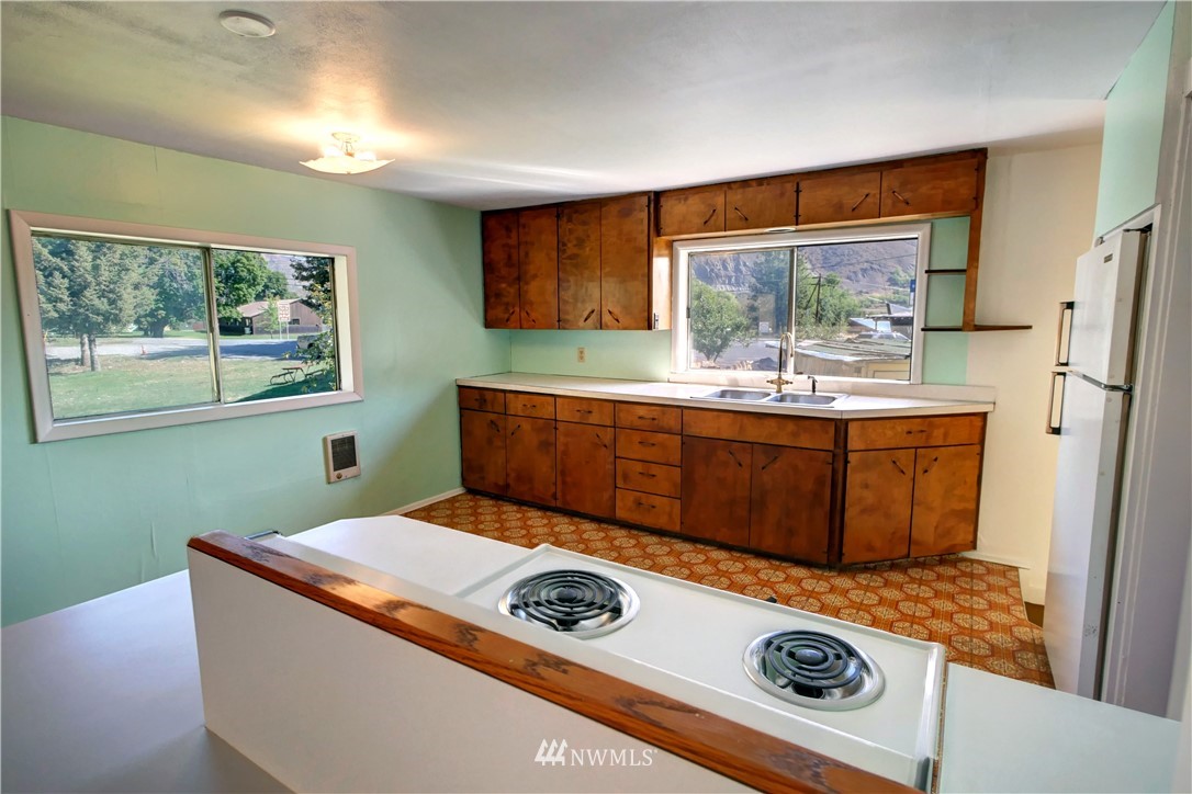 628 Twisp Carlton Road Twisp, WA 98856 - Photo 8 of 32 a view of kitchen with a window a washer and dryer