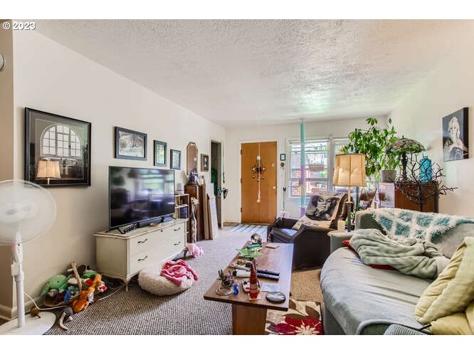 11 Northeast 62nd Avenue Portland, OR 97213 - Photo 11 of 28 a living room with furniture flat screen tv and a couch
