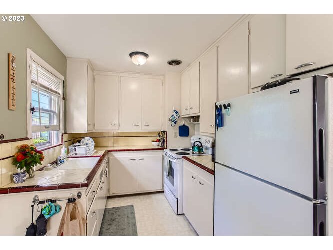 11 Northeast 62nd Avenue Portland, OR 97213 - Photo 16 of 28 a kitchen with a sink appliances cabinets and furniture