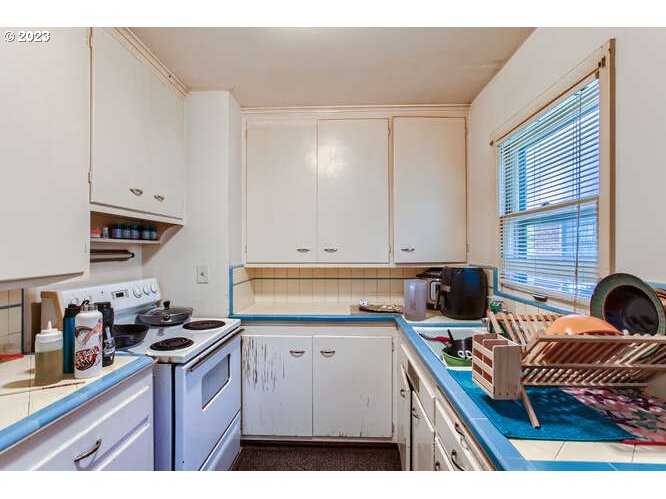 11 Northeast 62nd Avenue Portland, OR 97213 - Photo 17 of 28 a kitchen with a sink stove and cabinets