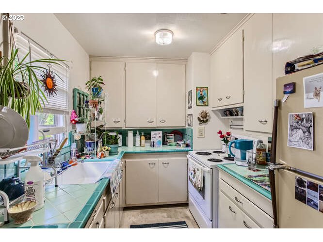 11 Northeast 62nd Avenue Portland, OR 97213 - Photo 18 of 28 a kitchen that has a lot of cabinets and wooden floor