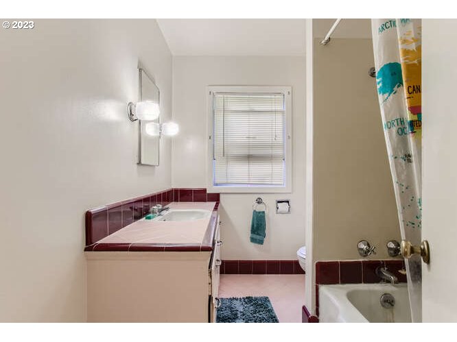 11 Northeast 62nd Avenue Portland, OR 97213 - Photo 20 of 28 a bathroom with a sink vanity and mirror