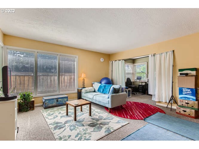 11 Northeast 62nd Avenue Portland, OR 97213 - Photo 8 of 28 a living room with furniture and a flat screen tv