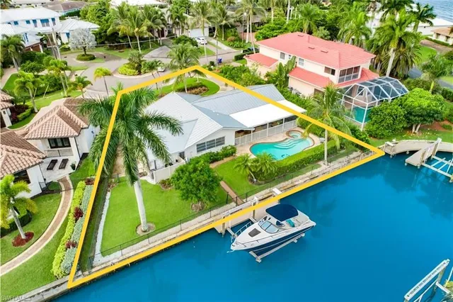 an aerial view of a residential houses with yard