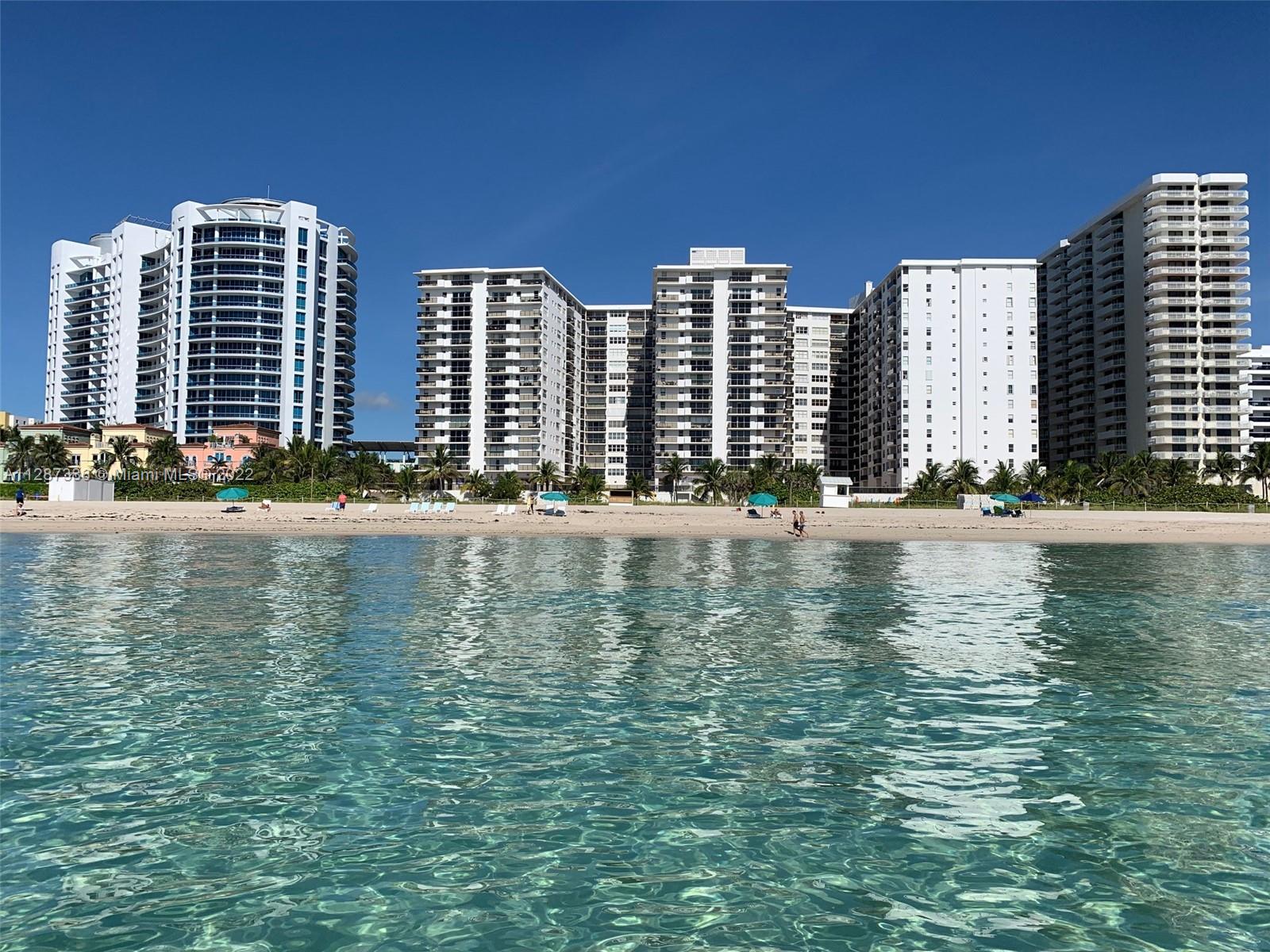a view of water with tall buildings