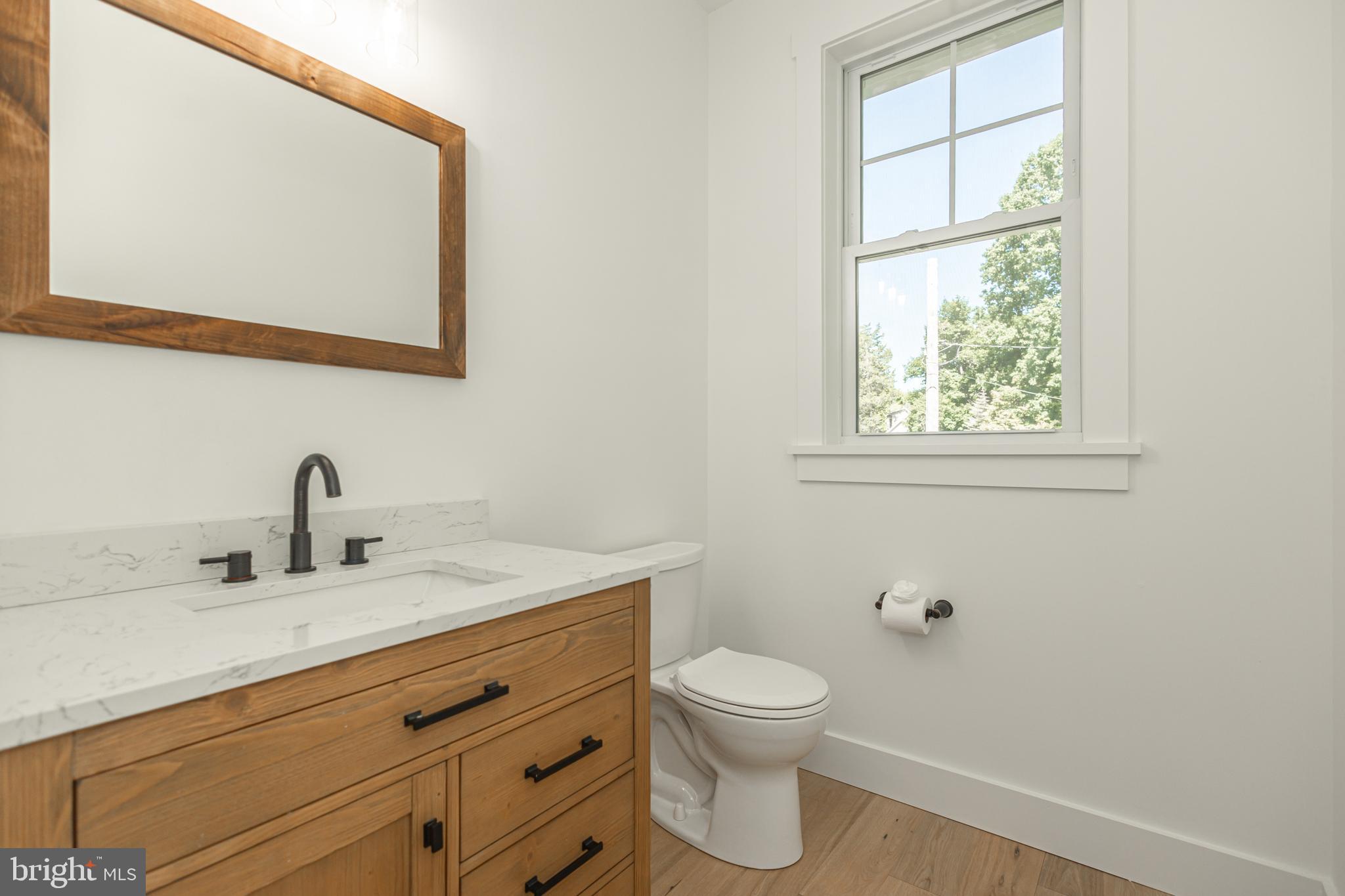 1764 River Road Upper Black Eddy, PA 18972 - Photo 16 of 37 a bathroom with a toilet sink vanity and mirror