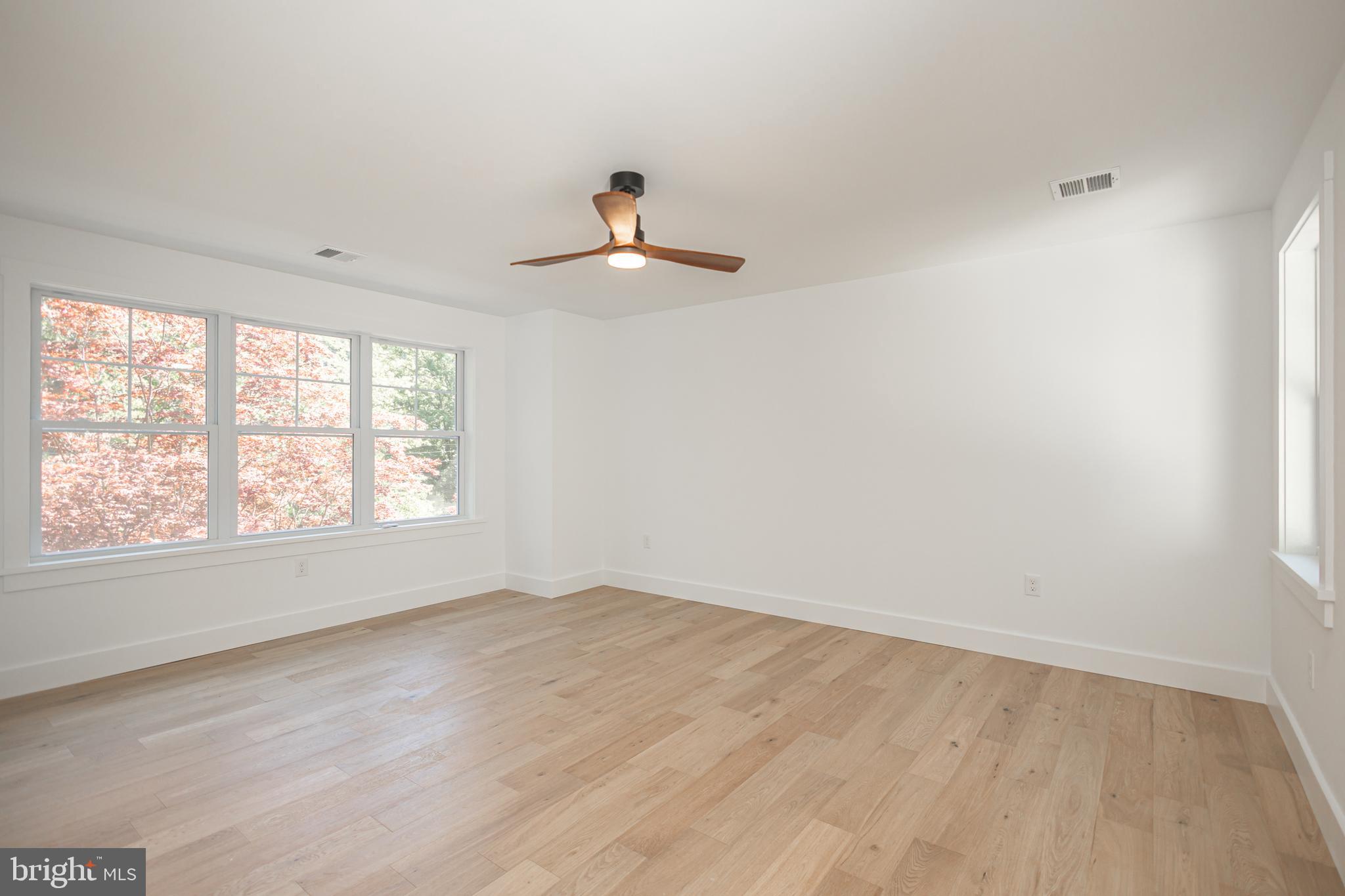 1764 River Road Upper Black Eddy, PA 18972 - Photo 25 of 37 an empty room with wooden floor ceiling fan and windows