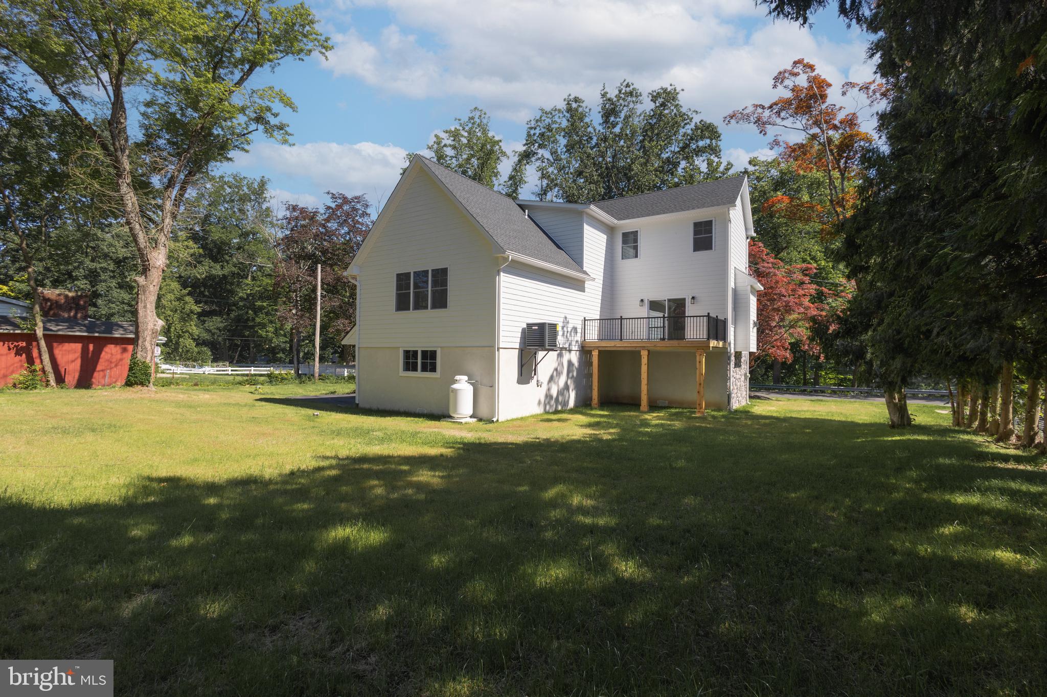 1764 River Road Upper Black Eddy, PA 18972 - Photo 30 of 37 a view of a house with backyard and a tree