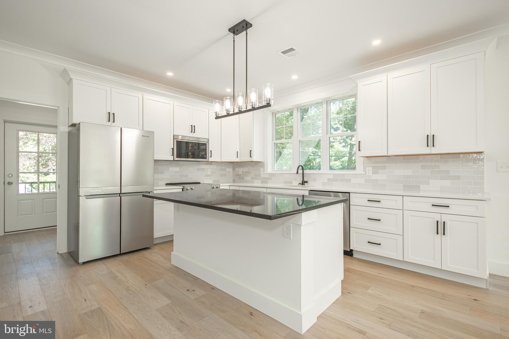 1764 River Road Upper Black Eddy, PA 18972 - Photo 5 of 37 a kitchen with granite countertop white cabinets and white appliances
