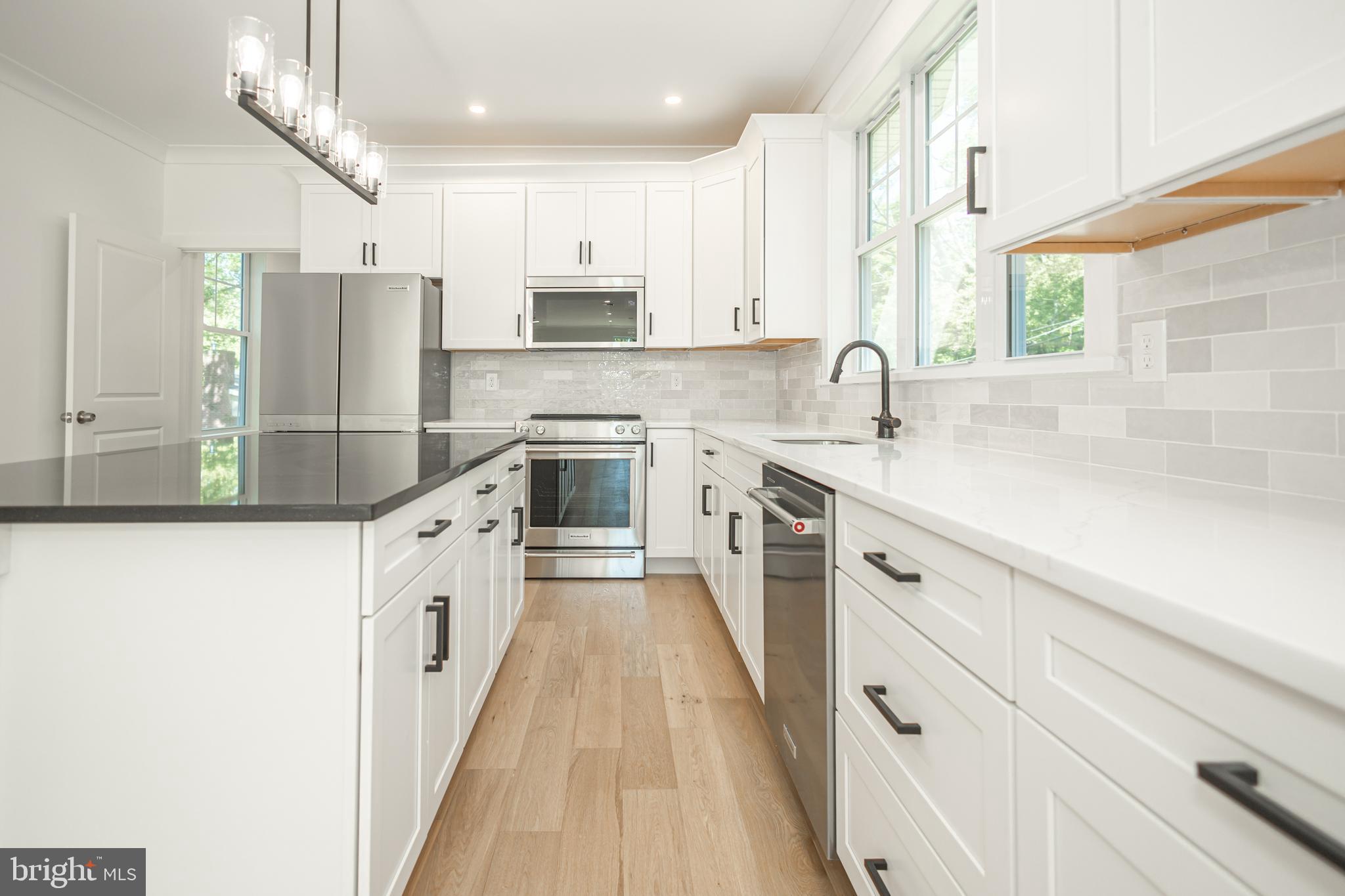 1764 River Road Upper Black Eddy, PA 18972 - Photo 6 of 37 a kitchen with kitchen island granite countertop a sink stainless steel appliances cabinets and a counter top space