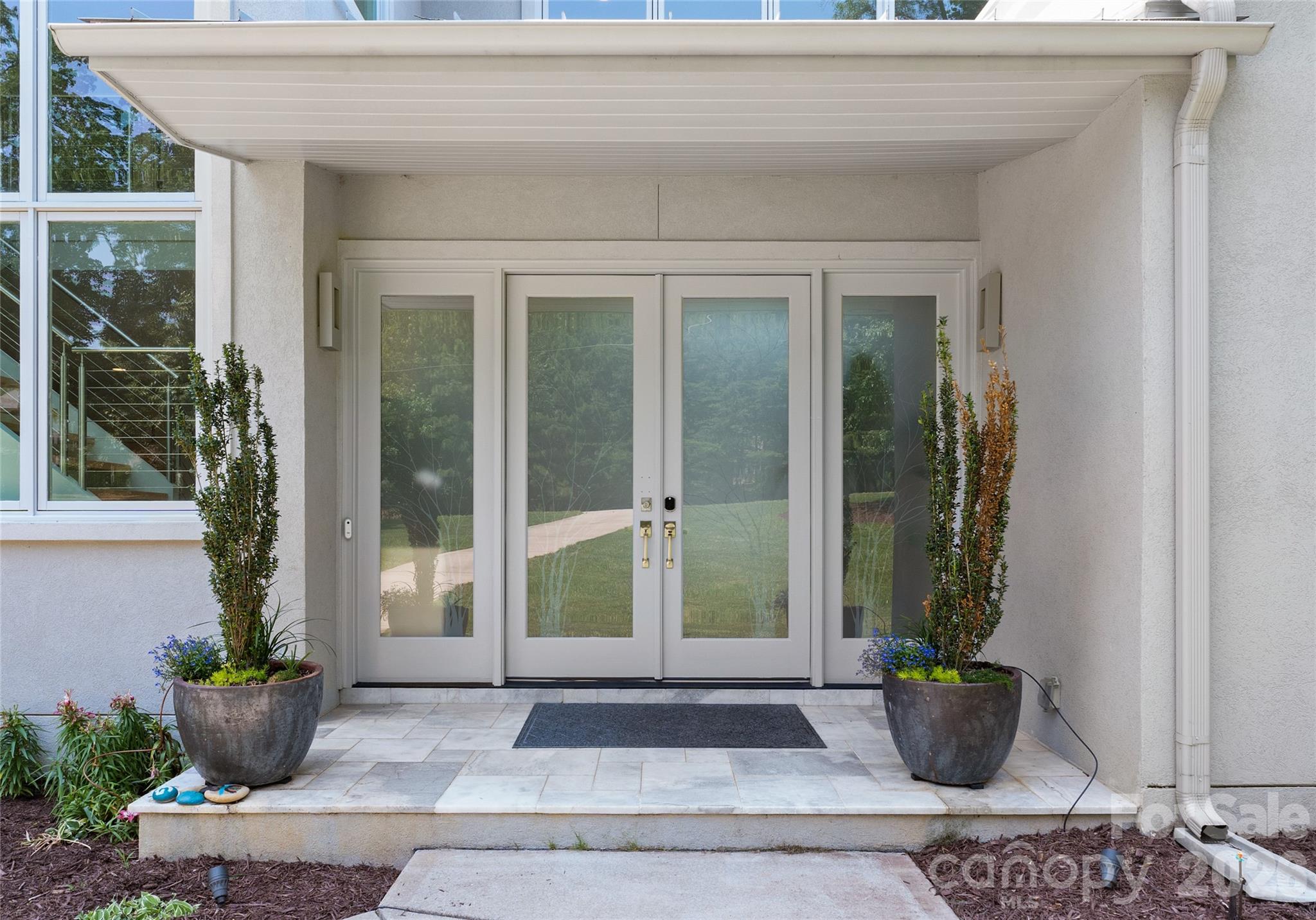 188 Blarney Road Mooresville, NC 28117 - Photo 6 of 48 a view of potted plants in front of glass door