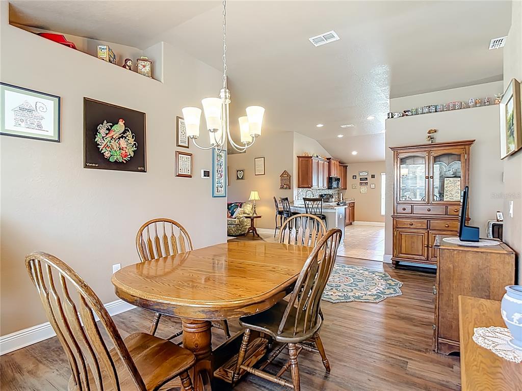 1170 Legatto Loop Dundee, FL 33838 - Photo 11 of 38 a dining room with furniture and wooden floor