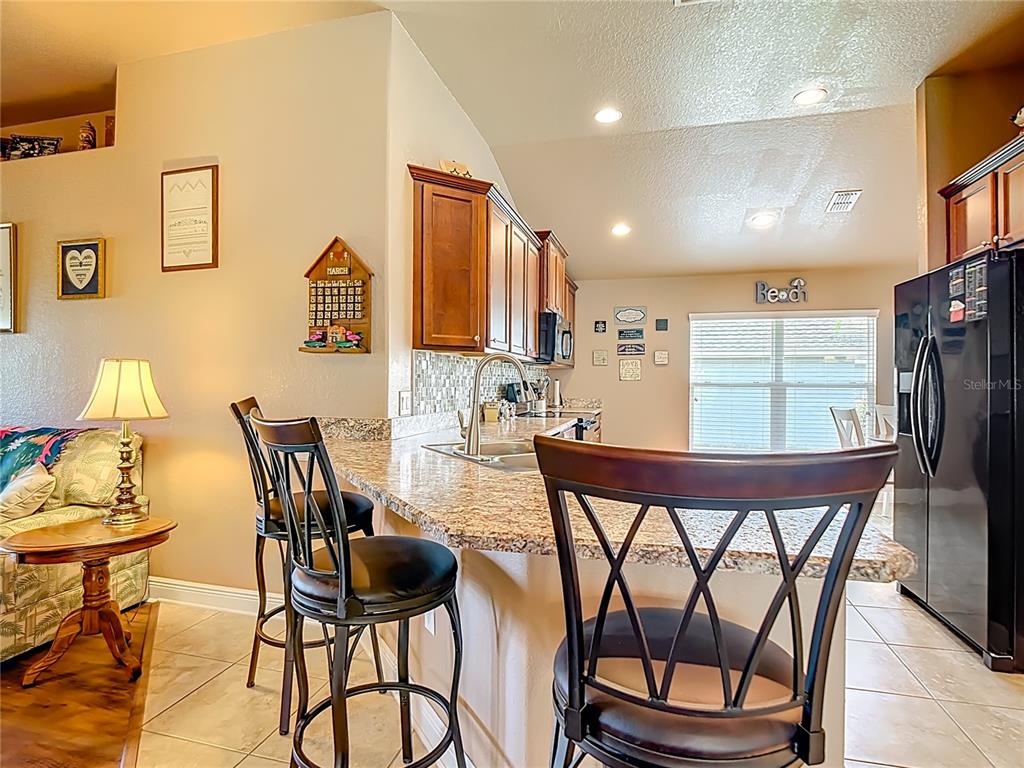 1170 Legatto Loop Dundee, FL 33838 - Photo 13 of 38 a view of a dining room with furniture and a large window