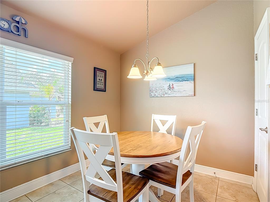 1170 Legatto Loop Dundee, FL 33838 - Photo 18 of 38 a view of a dining room with furniture and a window