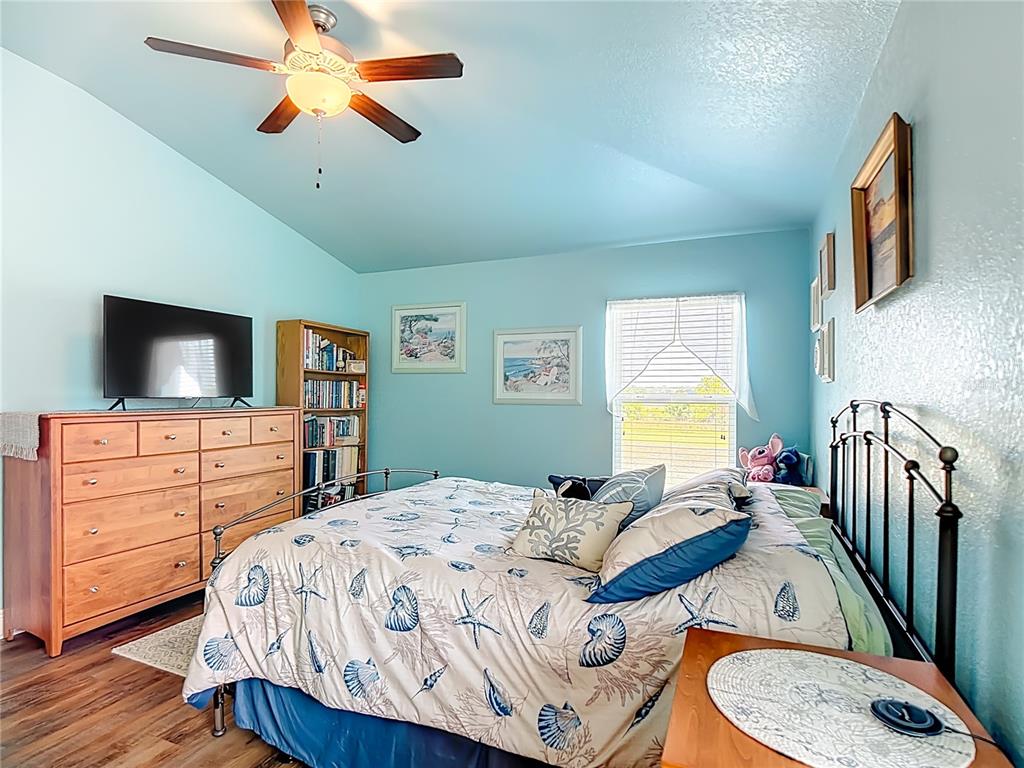 1170 Legatto Loop Dundee, FL 33838 - Photo 19 of 38 a bedroom with a bed and a flat screen tv