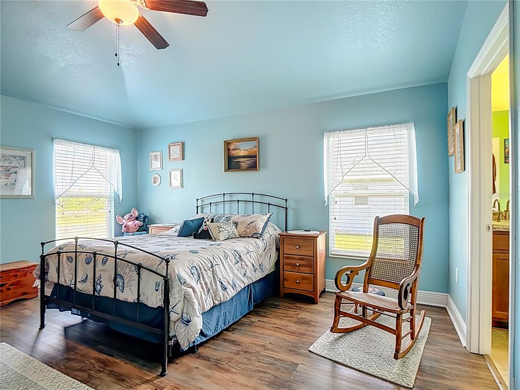 1170 Legatto Loop Dundee, FL 33838 - Photo 20 of 38 a bedroom with a bed chair and a window