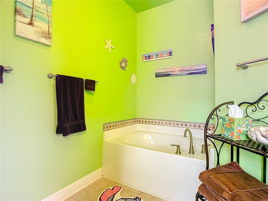 1170 Legatto Loop Dundee, FL 33838 - Photo 23 of 38 a bathroom with a bathtub and a window