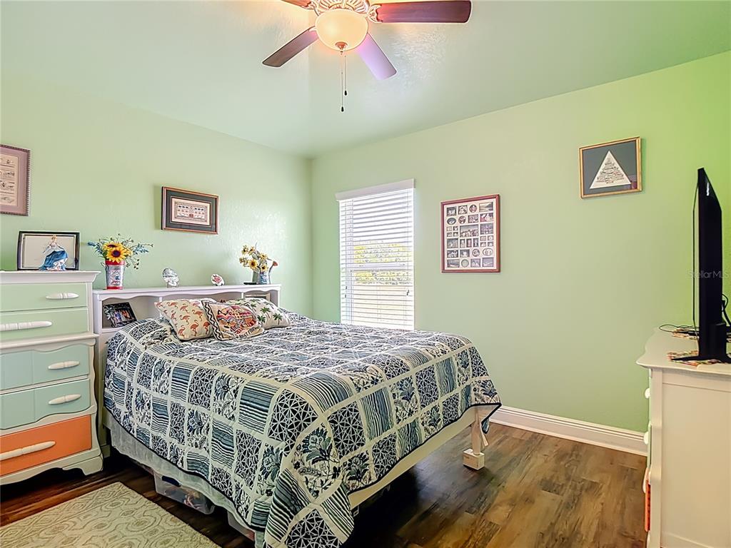 1170 Legatto Loop Dundee, FL 33838 - Photo 26 of 38 a bedroom with a bed and a flat screen tv