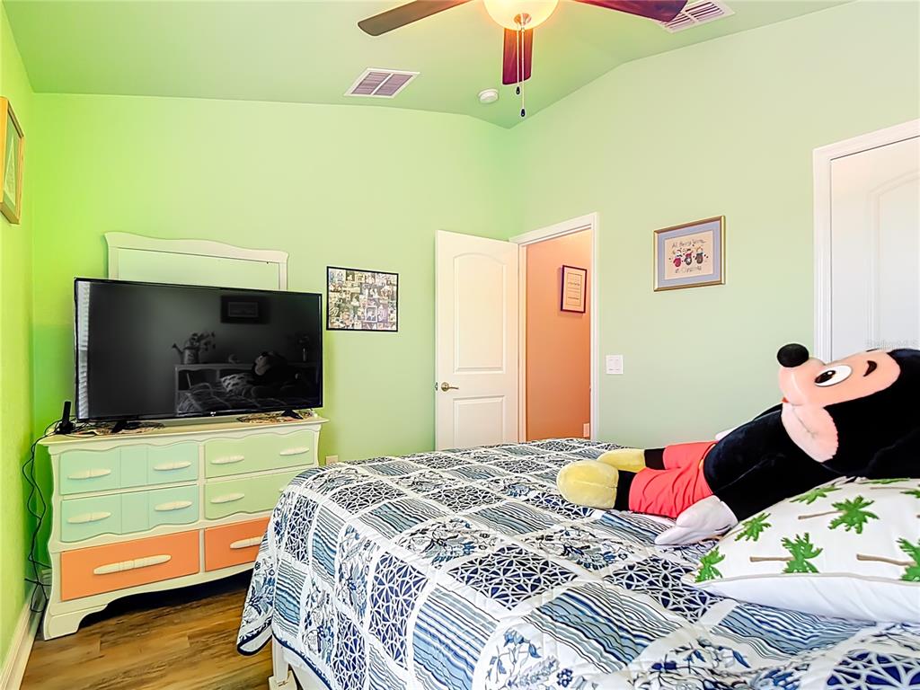 1170 Legatto Loop Dundee, FL 33838 - Photo 27 of 38 a bedroom with a bed and a flat screen tv