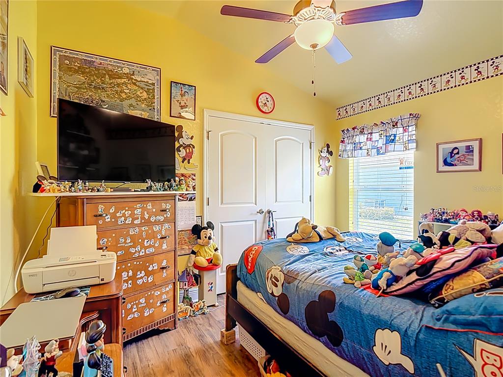 1170 Legatto Loop Dundee, FL 33838 - Photo 29 of 38 a bedroom with a bed and flat screen tv