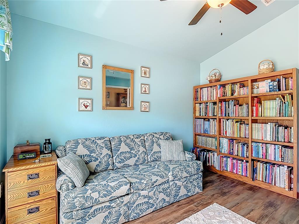 1170 Legatto Loop Dundee, FL 33838 - Photo 32 of 38 a living room with a couch and a book shelf