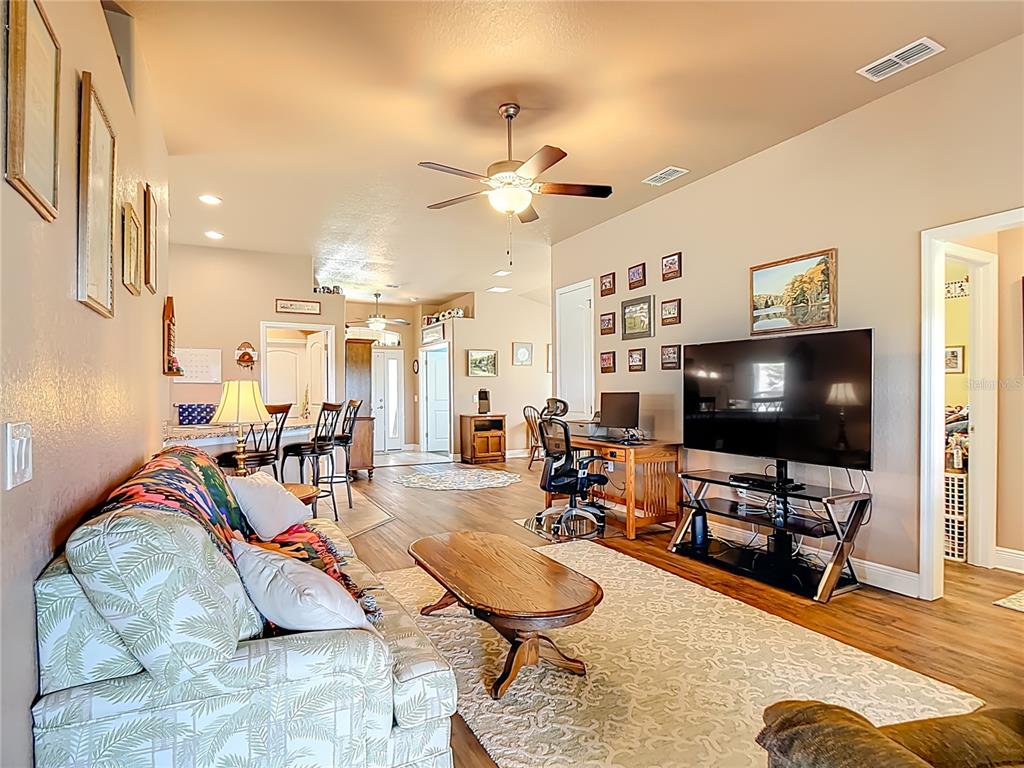 1170 Legatto Loop Dundee, FL 33838 - Photo 7 of 38 a living room with furniture and a flat screen tv