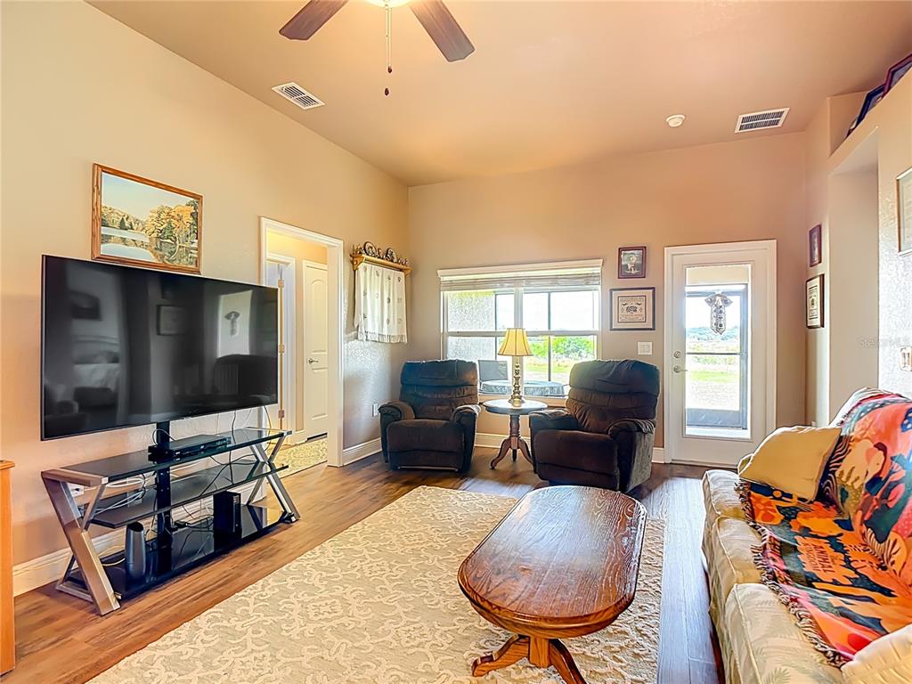 1170 Legatto Loop Dundee, FL 33838 - Photo 8 of 38 a living room with furniture and a flat screen tv