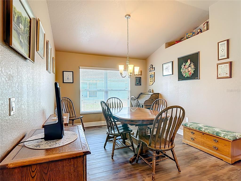 1170 Legatto Loop Dundee, FL 33838 - Photo 9 of 38 a view of a dining room with furniture window and wooden floor