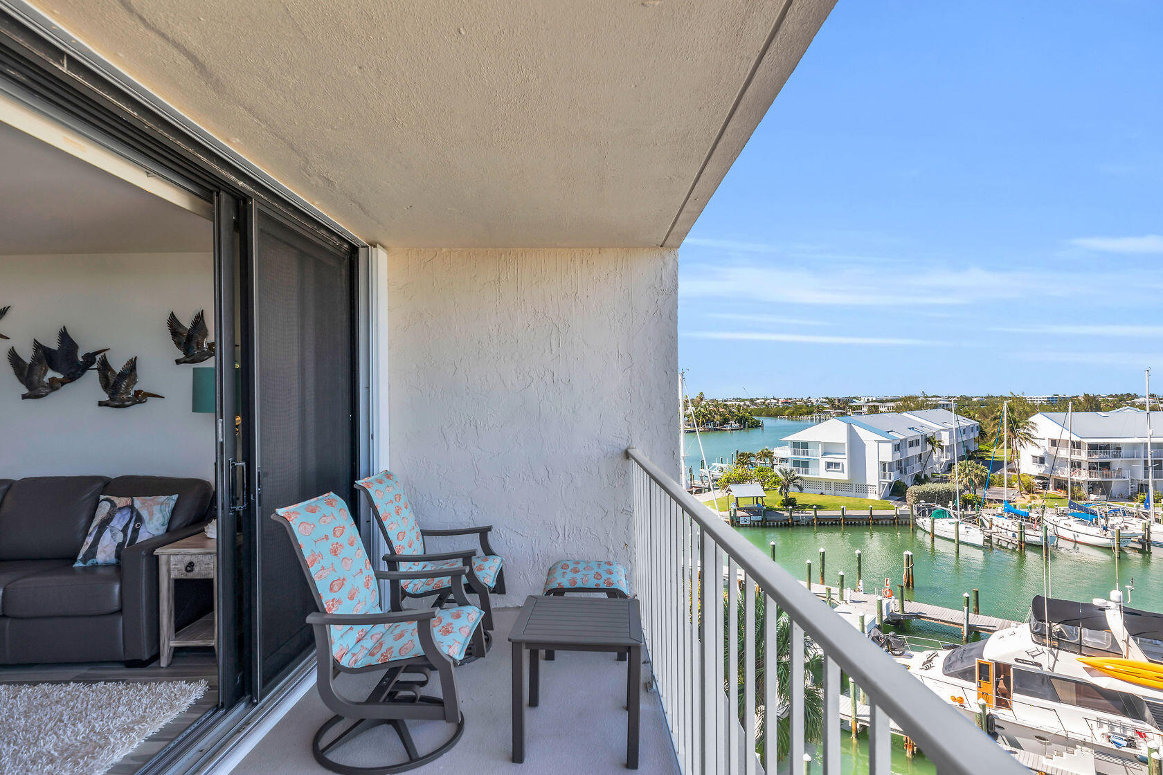 2000 Coco Plum Drive, Unit 503 Marathon, FL 33050 - Photo 13 of 37 a balcony with wooden floor and outdoor seating