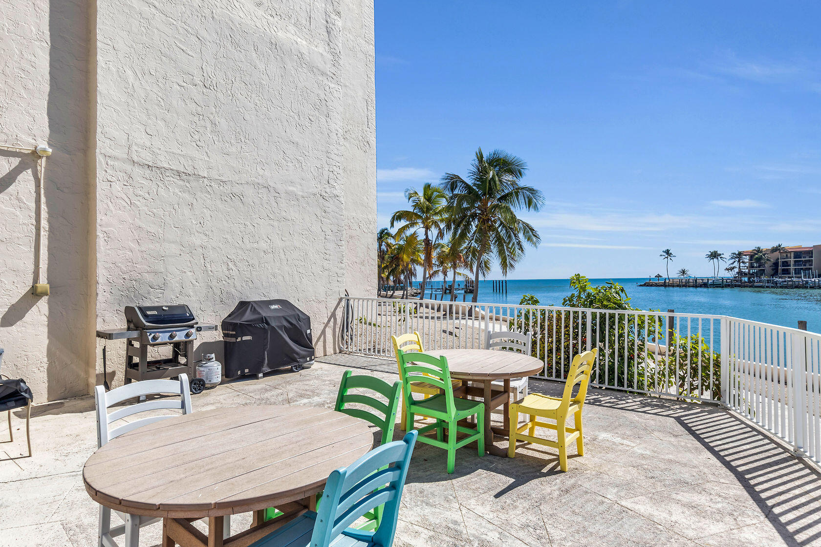 2000 Coco Plum Drive, Unit 503 Marathon, FL 33050 - Photo 27 of 37 a view of a balcony with chairs and a table