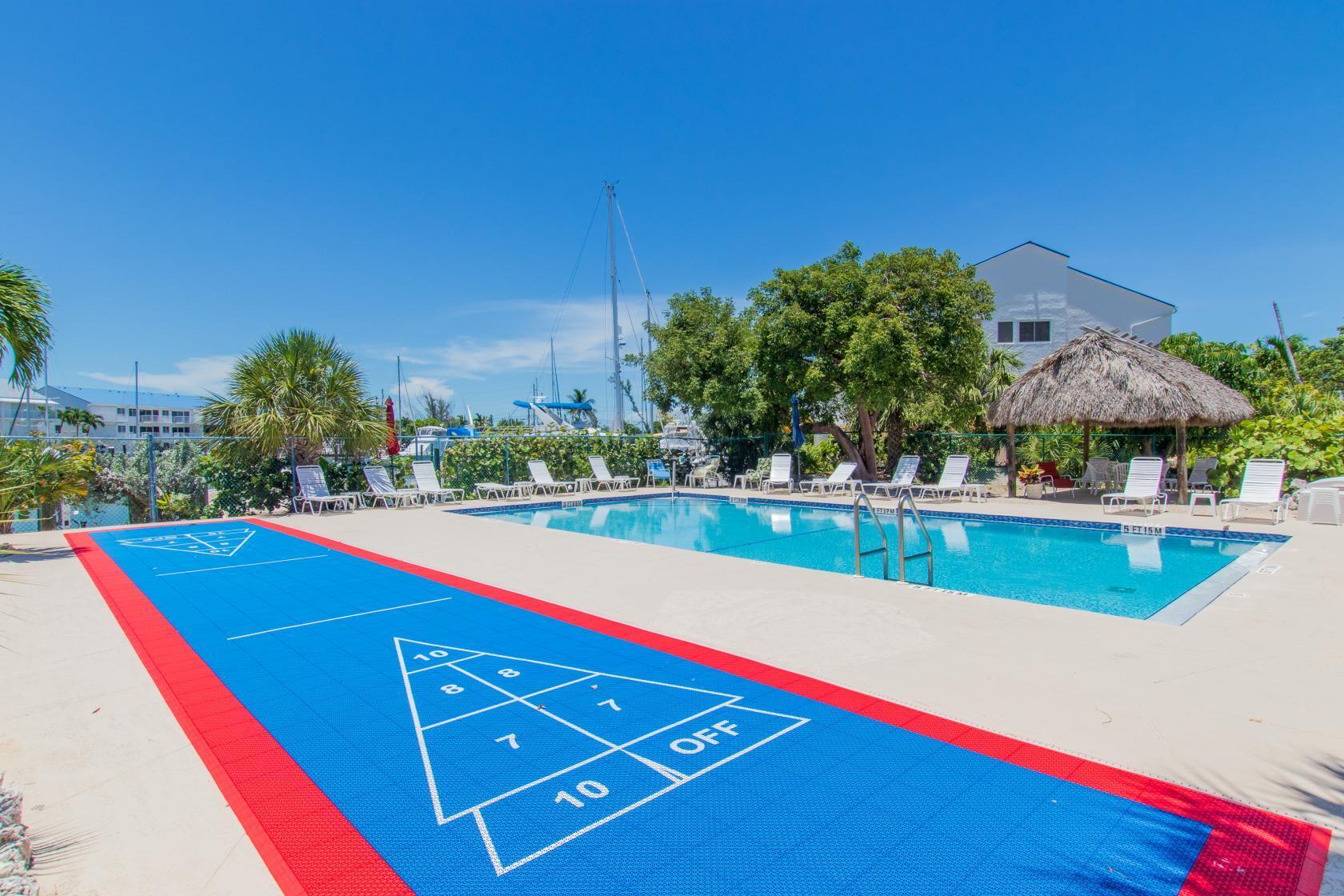 2000 Coco Plum Drive, Unit 503 Marathon, FL 33050 - Photo 31 of 37 a view of swimming pool with outdoor seating and yard