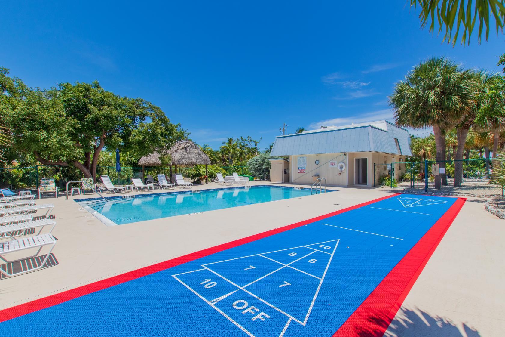 2000 Coco Plum Drive, Unit 503 Marathon, FL 33050 - Photo 33 of 37 a view of swimming pool with outdoor seating and yard