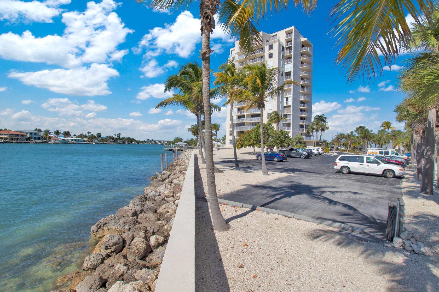 2000 Coco Plum Drive, Unit 503 Marathon, FL 33050 - Photo 36 of 37 a view of a lake with a building in the background