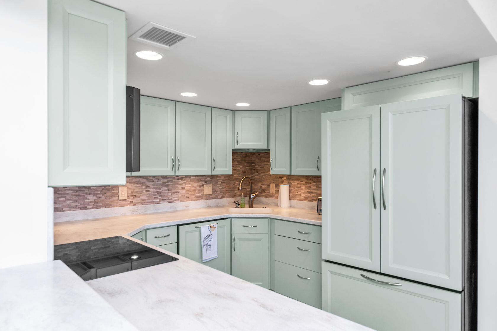 2000 Coco Plum Drive, Unit 503 Marathon, FL 33050 - Photo 7 of 37 a kitchen with kitchen island a counter top space a sink and cabinets