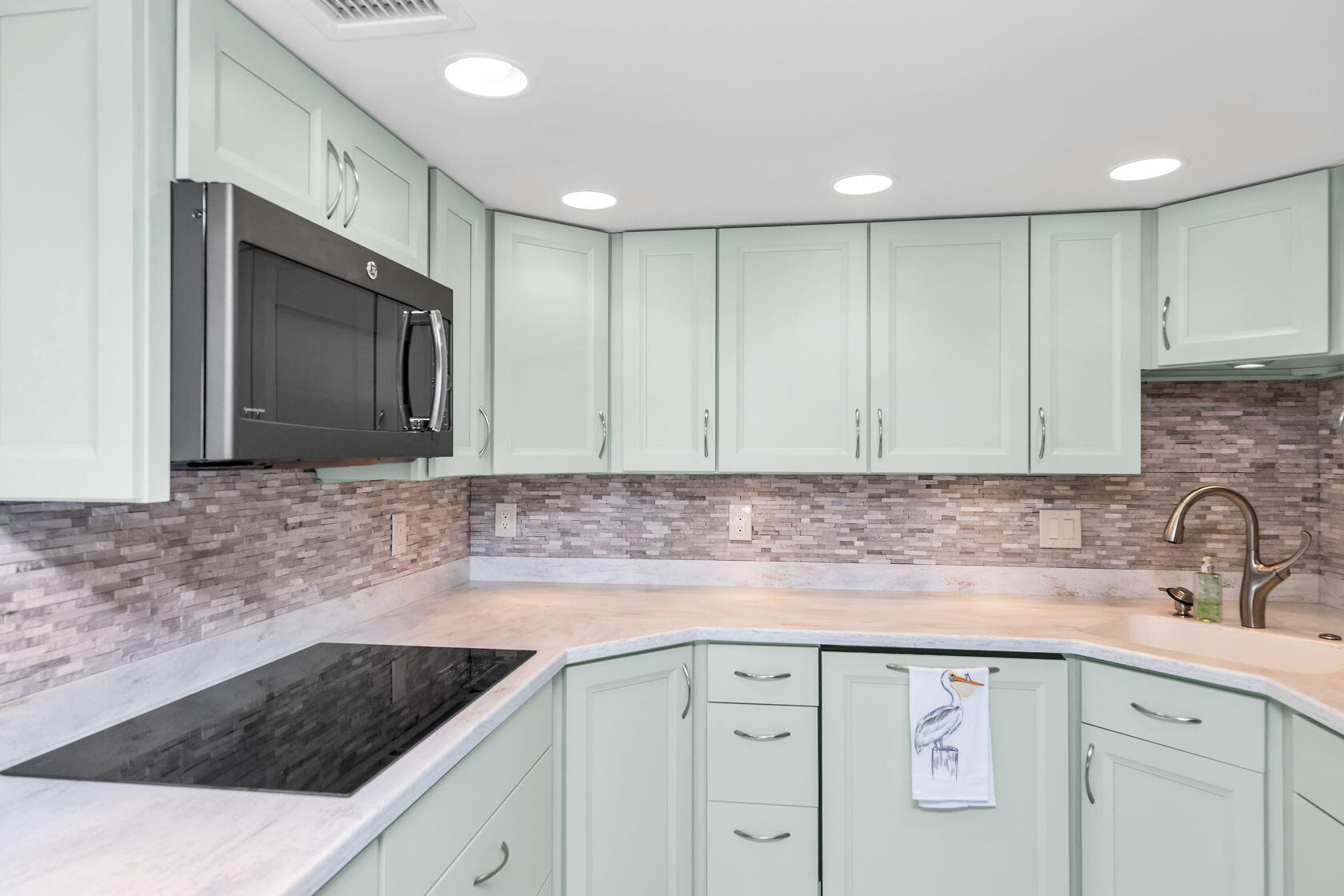 2000 Coco Plum Drive, Unit 503 Marathon, FL 33050 - Photo 8 of 37 a kitchen with stainless steel appliances granite countertop a sink a stove a microwave and cabinets