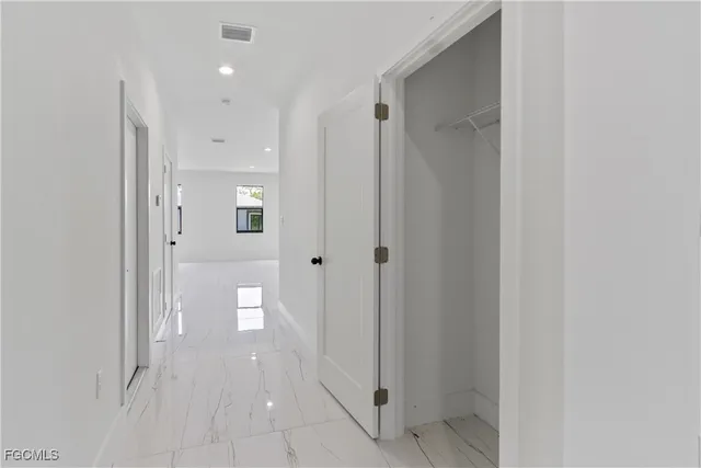 a kitchen with stainless steel appliances granite countertop a refrigerator and a stove