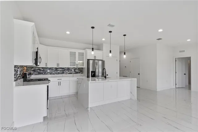 a view of a kitchen with a sink windows and a chandelier