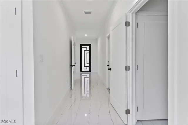 a view of a hallway with white walls