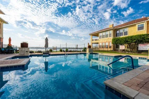 a swimming pool view with a outdoor seating