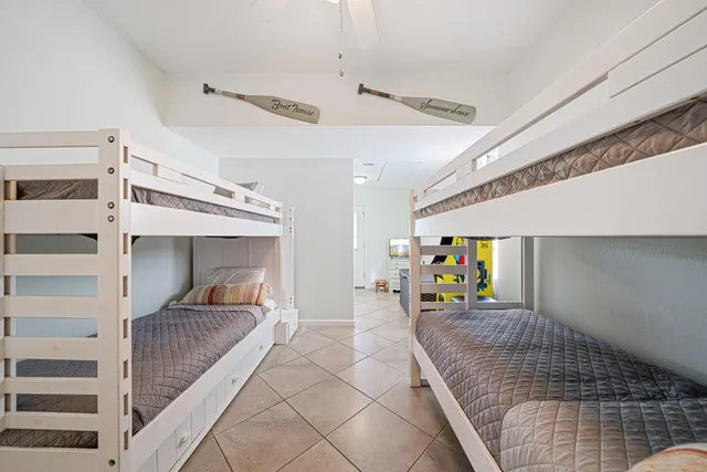 a spacious bedroom with a bed a couch and a chandelier