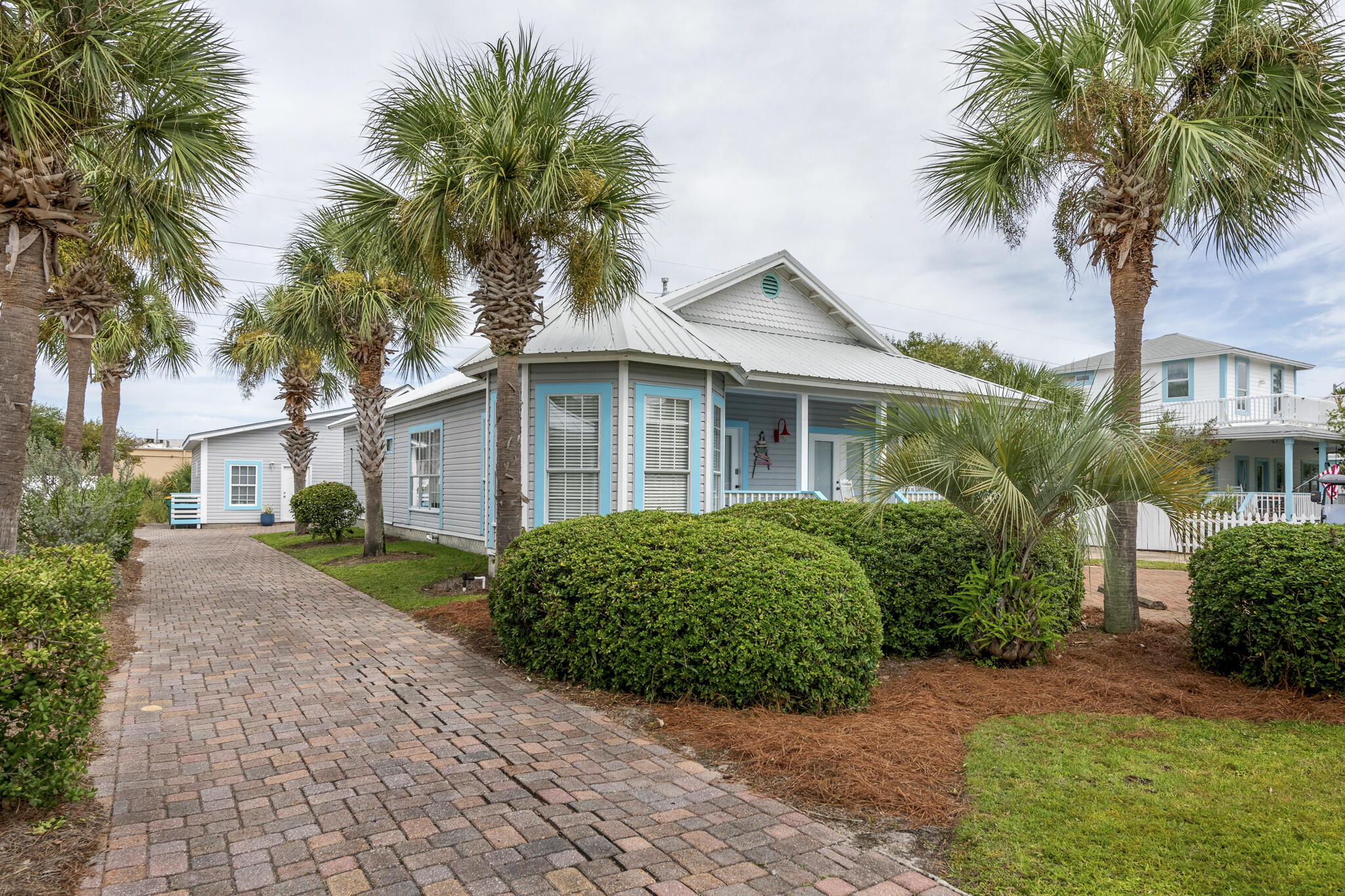 4431 Luke Avenue Destin, FL 32541 - Photo 2 of 100 a front view of a house with a garden and palm trees