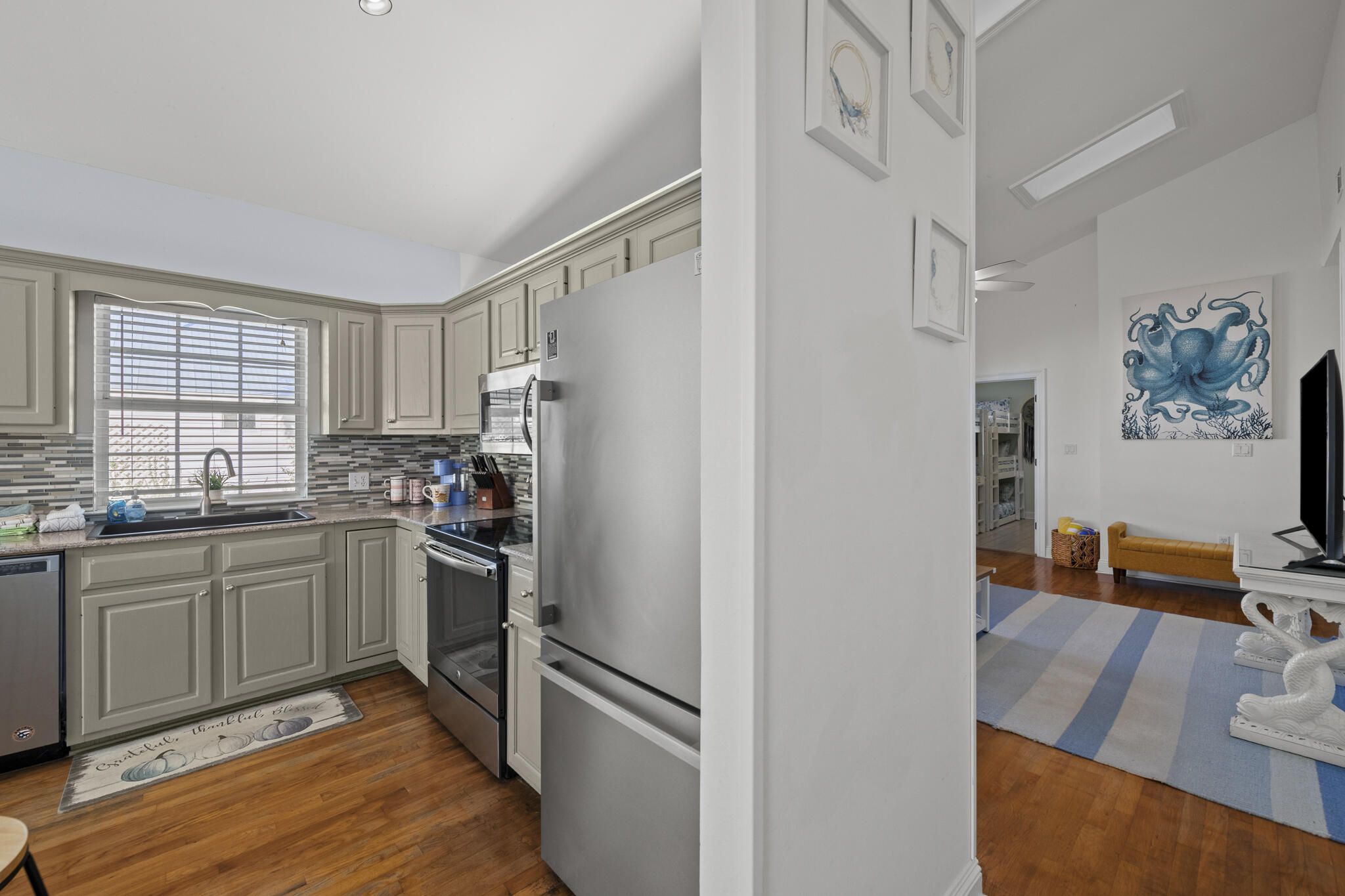 4431 Luke Avenue Destin, FL 32541 - Photo 21 of 100 a kitchen with stainless steel appliances granite countertop a refrigerator and a sink