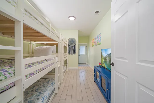 a bedroom with a bed and a chandelier