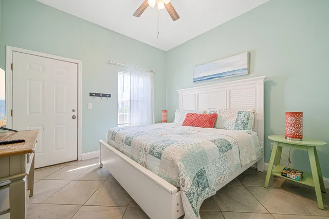 a bedroom with a bed and a mirror on dresser