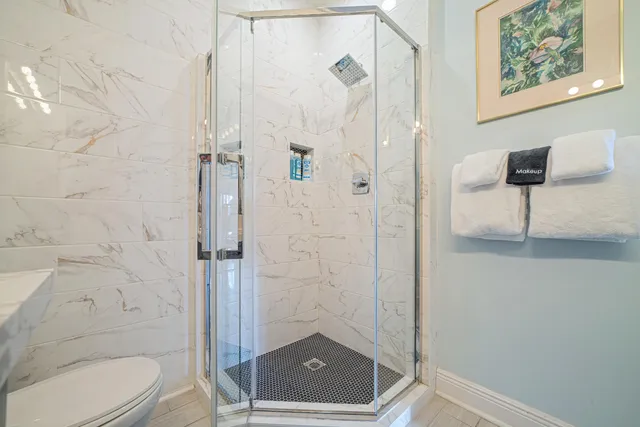 a bathroom with a toilet a sink a vanity and mirror