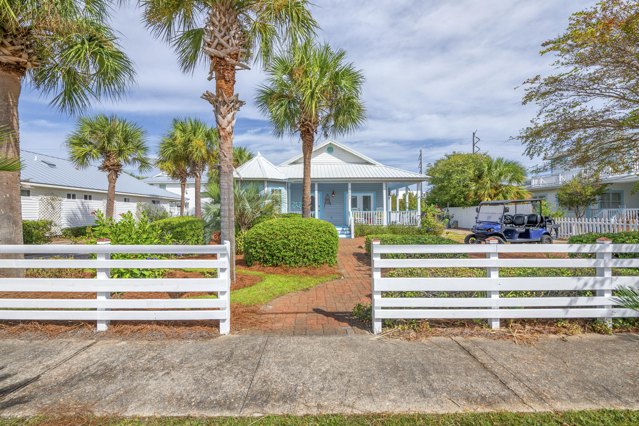 4431 Luke Avenue Destin, FL 32541 - Photo 4 of 100 a front view of a house with a garden and plants