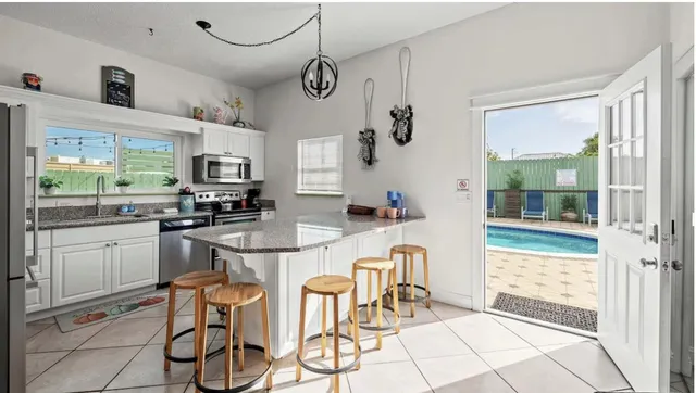 a view of a chairs and table on the wooden floor