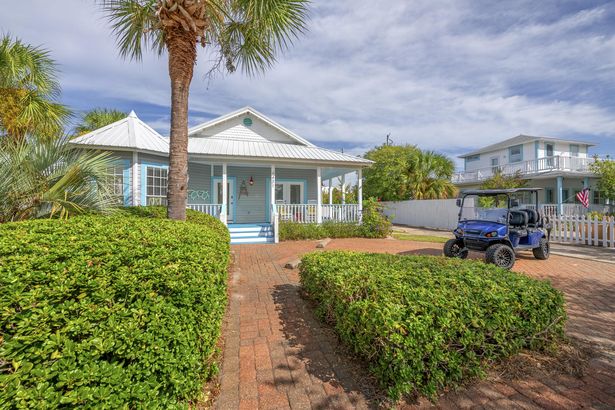 4431 Luke Avenue Destin, FL 32541 - Photo 5 of 100 a front view of a house with garden and porch