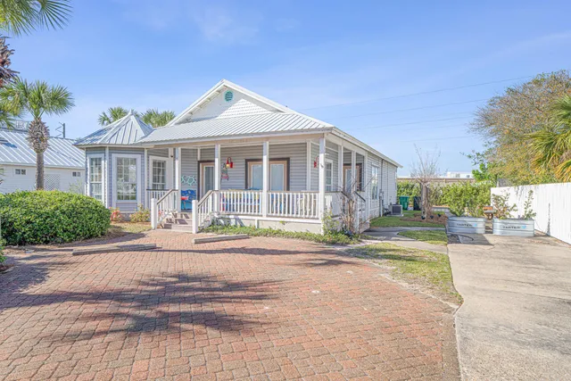 a front view of a house with a porch and a yard