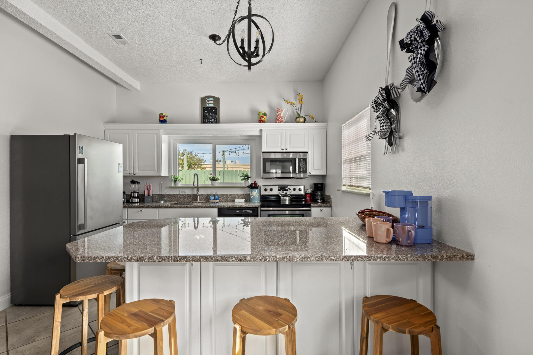 4431 Luke Avenue Destin, FL 32541 - Photo 80 of 100 a kitchen with stainless steel appliances granite countertop a sink and cabinets